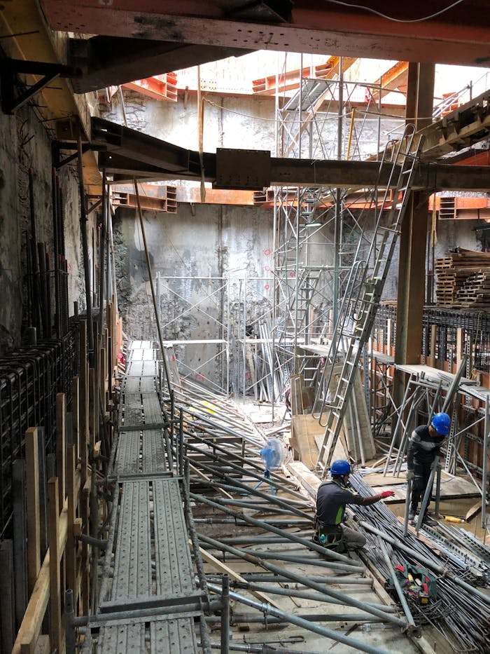 why-choose-us-02 Construction site with scaffolding and workers in Taiwan, showcasing urban development.